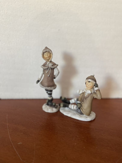 Set of Christmas Figures 1 Standing Girl 1 Sitting Boy Ice Skates